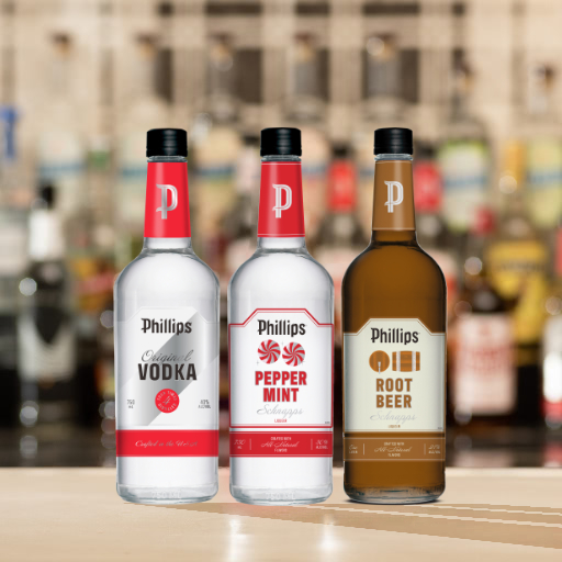 A bottle of vodka and three bottles of schnapps on a bar