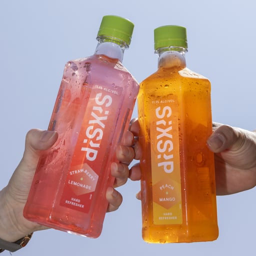 A bottle of whiskey in a wood room on a wood table