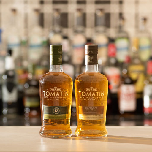 A bottle of scotch in front of a waterfall