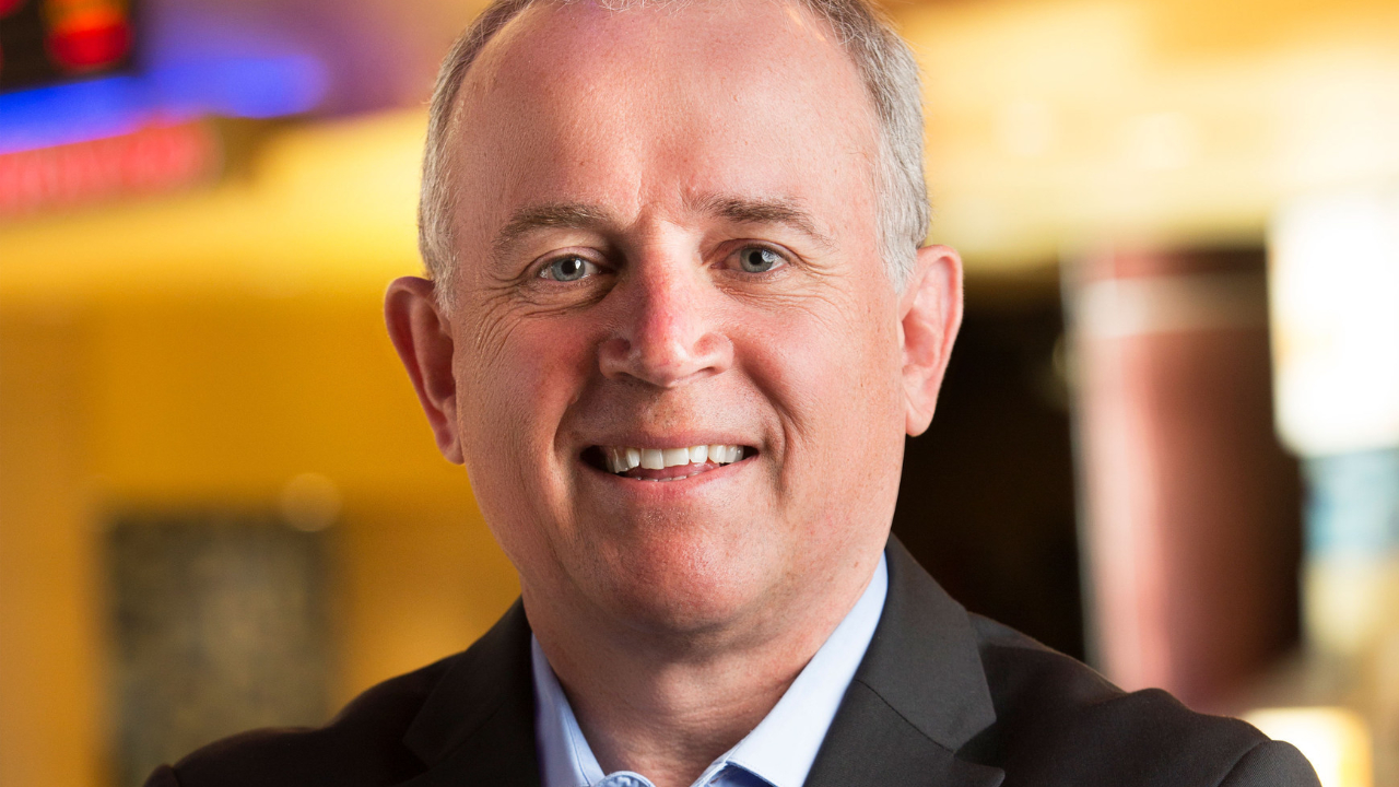 A portrait of Andrew England smiling